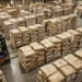 Bags of coconut charcoal products stacked and ready for export at a warehouse facility